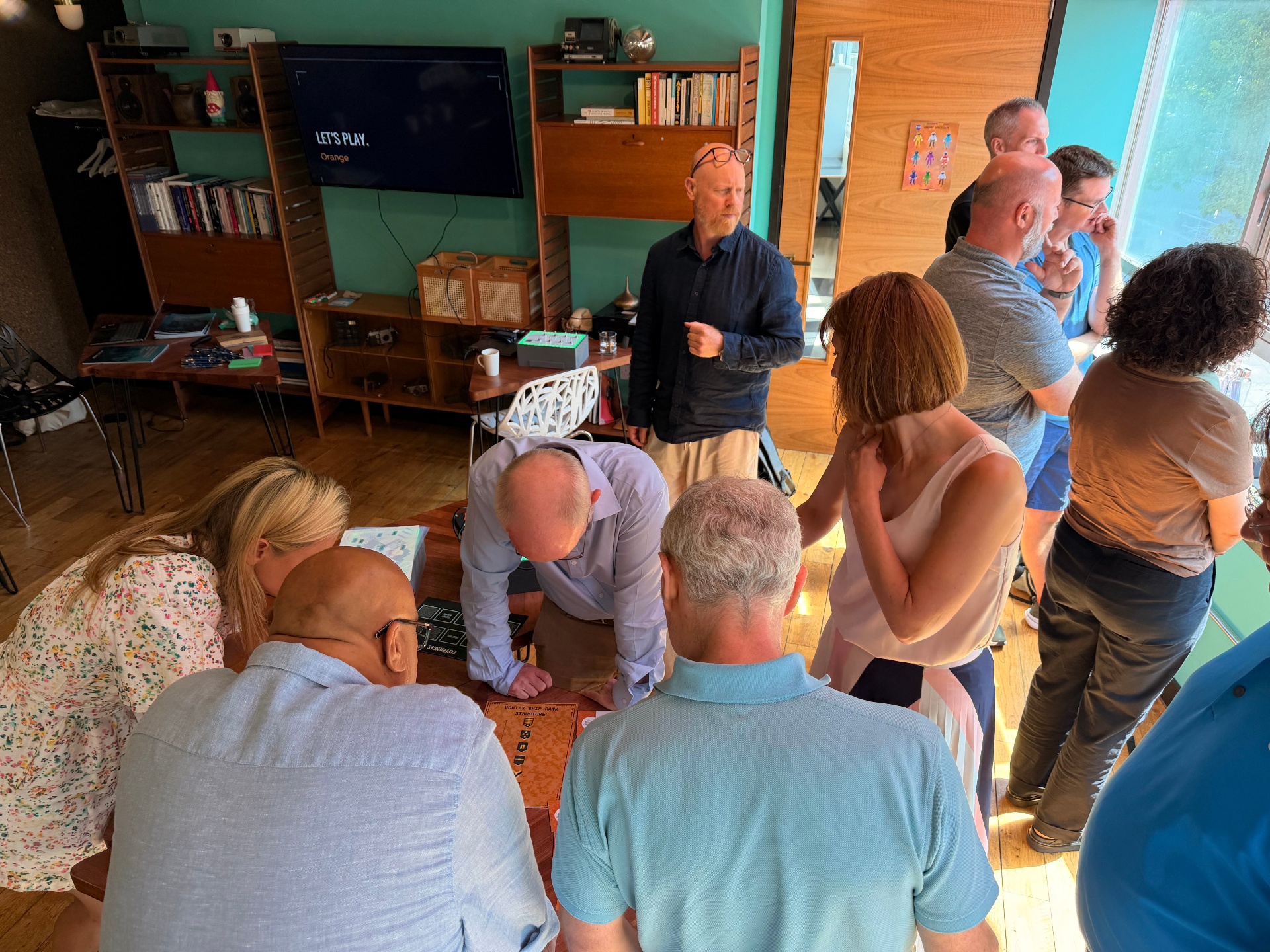 Group gathered around an UNPACK experience in a informal workspace